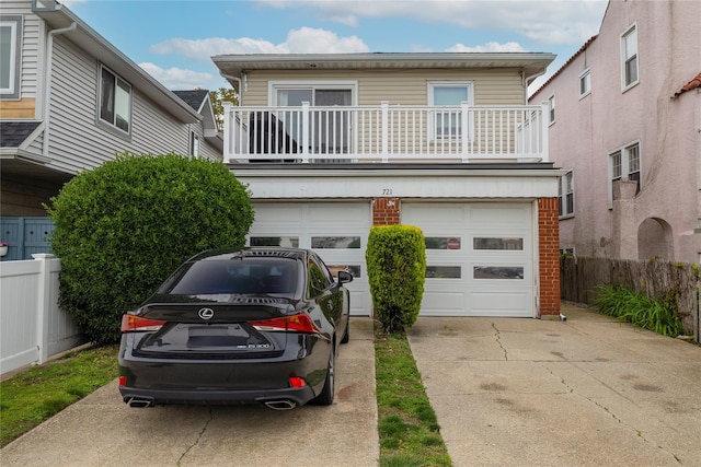 721 E Walnut St, Long Beach, NY 11561 - view of front of home with a garage, driveway, a balcony, and brick siding