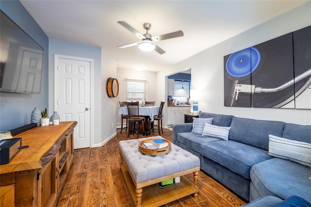 721 E Walnut St, Long Beach, NY 11561 - living room with dark wood-style flooring, ceiling fan, and baseboards