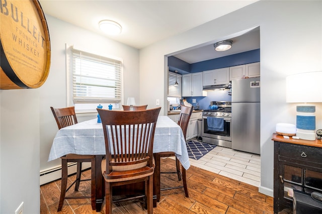 721 E Walnut St, Long Beach, NY 11561 - dining area featuring a baseboard radiator and light wood-style floors