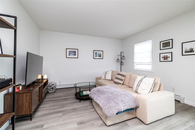 721 E Walnut St, Long Beach, NY 11561 - living room featuring light wood finished floors, baseboard heating, and baseboards