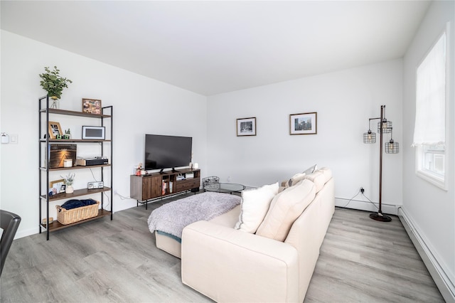721 E Walnut St, Long Beach, NY 11561 - living room featuring baseboard heating, light wood-type flooring, healthy amount of natural light, and baseboards
