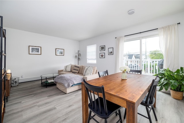 721 E Walnut St, Long Beach, NY 11561 - dining room featuring light wood-style flooring and a baseboard radiator