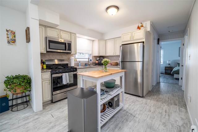 721 E Walnut St, Long Beach, NY 11561 - kitchen with stainless steel appliances, butcher block countertops, light wood-type flooring, and plenty of natural light