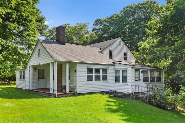 3868 Indian Hill Rd, Shrub Oak, NY 10588 - view of front of home with a chimney, roof with shingles, a front lawn, and covered porch