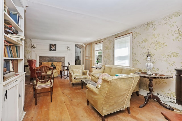 3868 Indian Hill Rd, Shrub Oak, NY 10588 - living room with wallpapered walls, light wood-style floors, and a brick fireplace