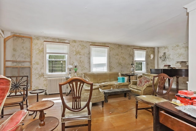 3868 Indian Hill Rd, Shrub Oak, NY 10588 - living room featuring radiator heating unit, wallpapered walls, and wood finished floors