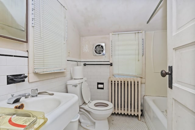 3868 Indian Hill Rd, Shrub Oak, NY 10588 - full bath featuring radiator, tile walls, a tub, tile patterned floors, and vaulted ceiling