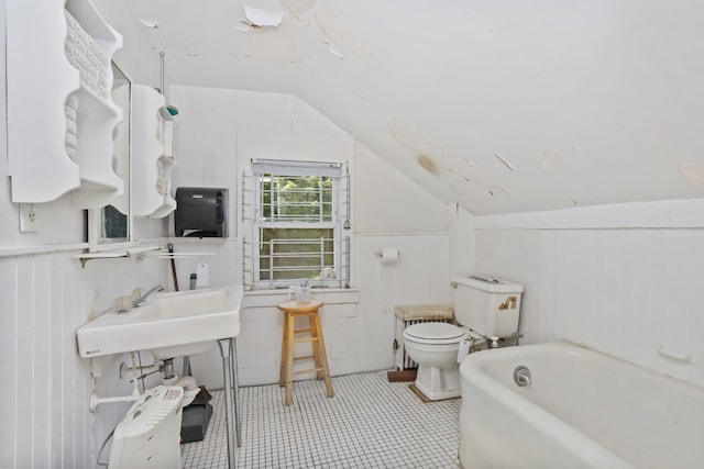 3868 Indian Hill Rd, Shrub Oak, NY 10588 - full bath with vaulted ceiling, a bath, a wainscoted wall, and tile patterned floors