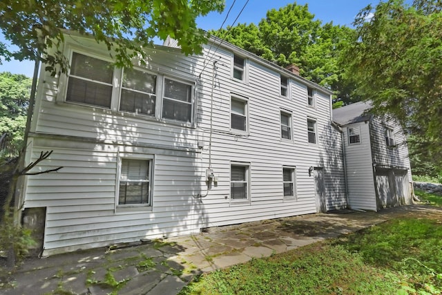 3868 Indian Hill Rd, Shrub Oak, NY 10588 - view of side of property with a patio and a chimney