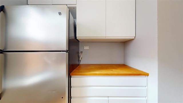 65-35 108th St Unit D7, Forest Hills, NY 11375 - kitchen featuring freestanding refrigerator, butcher block counters, and white cabinets