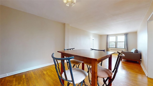 65-35 108th St Unit D7, Forest Hills, NY 11375 - dining area with baseboards, light wood-type flooring, and radiator heating unit