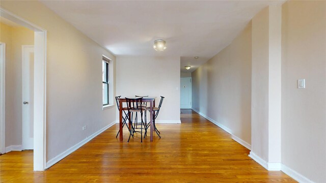 65-35 108th St Unit D7, Forest Hills, NY 11375 - dining room with light wood-type flooring and baseboards