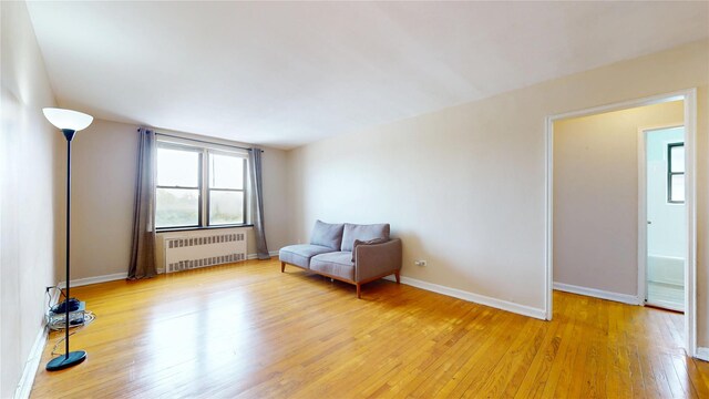 65-35 108th St Unit D7, Forest Hills, NY 11375 - sitting room with radiator heating unit, light wood-style floors, and baseboards