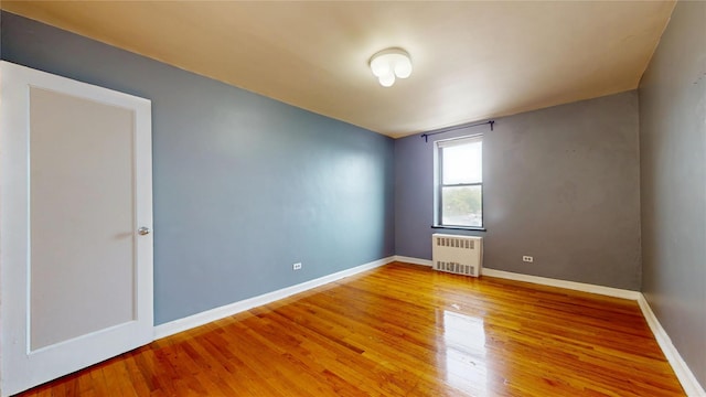 65-35 108th St Unit D7, Forest Hills, NY 11375 - unfurnished room with radiator heating unit, wood finished floors, and baseboards