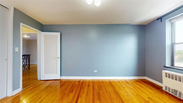 65-35 108th St Unit D7, Forest Hills, NY 11375 - spare room with radiator, light wood finished floors, baseboards, and healthy amount of natural light