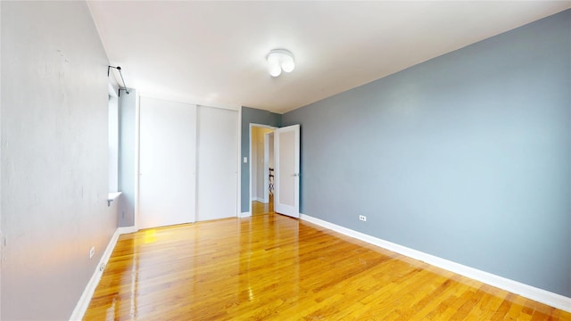 65-35 108th St Unit D7, Forest Hills, NY 11375 - unfurnished bedroom with light wood-style flooring, baseboards, and a closet