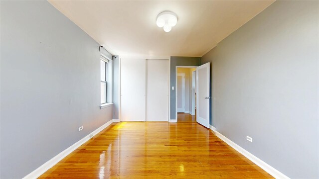 65-35 108th St Unit D7, Forest Hills, NY 11375 - unfurnished bedroom with light wood-style floors, a closet, and baseboards