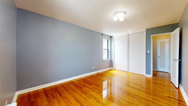 65-35 108th St Unit D7, Forest Hills, NY 11375 - unfurnished bedroom with light wood-style flooring, baseboards, and a closet