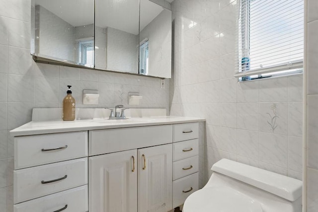 73 Fox Pl, Hicksville, NY 11801 - bathroom with tile walls, healthy amount of natural light, toilet, and vanity