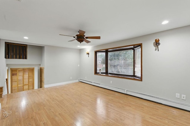 73 Fox Pl, Hicksville, NY 11801 - unfurnished living room with a baseboard heating unit, a ceiling fan, recessed lighting, wood finished floors, and baseboards