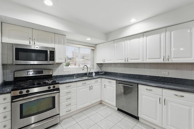 73 Fox Pl, Hicksville, NY 11801 - kitchen with stainless steel appliances, a sink, white cabinetry, light tile patterned floors, and recessed lighting