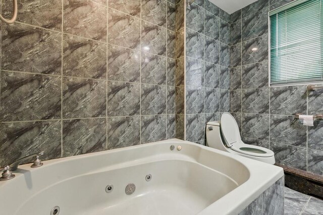 73 Fox Pl, Hicksville, NY 11801 - bathroom featuring toilet, a whirlpool tub, and tile walls