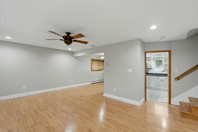 73 Fox Pl, Hicksville, NY 11801 - unfurnished living room with baseboard heating, a ceiling fan, a sink, recessed lighting, and stairway