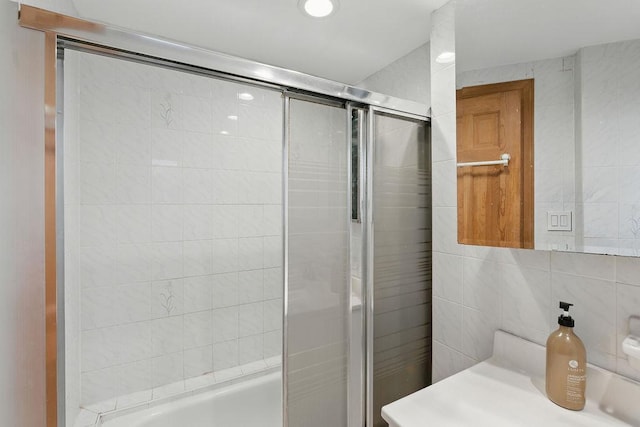 73 Fox Pl, Hicksville, NY 11801 - bathroom featuring tile walls, vanity, and shower / bath combination with glass door