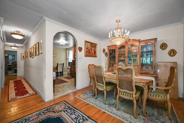211-40 18th Ave Unit 4A, Bayside, NY 11360 - dining space featuring arched walkways, crown molding, a chandelier, and light wood-style floors