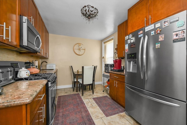 211-40 18th Ave Unit 4A, Bayside, NY 11360 - kitchen featuring appliances with stainless steel finishes, brown cabinets, light stone countertops, and backsplash