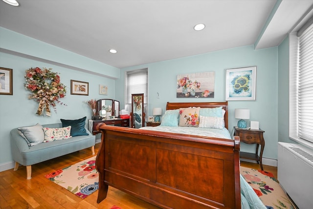211-40 18th Ave Unit 4A, Bayside, NY 11360 - bedroom with radiator heating unit, light wood-type flooring, multiple windows, and recessed lighting