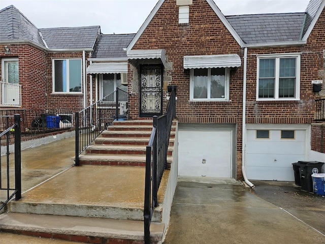 199-06 24th Rd, Whitestone, NY 11357 - view of property with a high end roof, brick siding, concrete driveway, and an attached garage