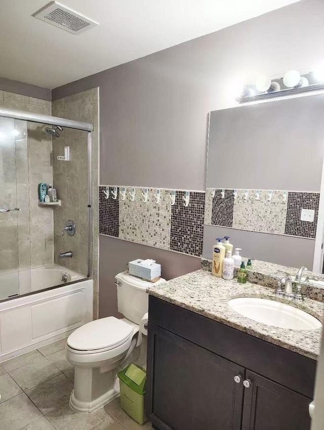 2-18A Constitution Pl Unit 173, College Point, NY 11356 - full bath featuring vanity, toilet, tile walls, enclosed tub / shower combo, and tile patterned flooring