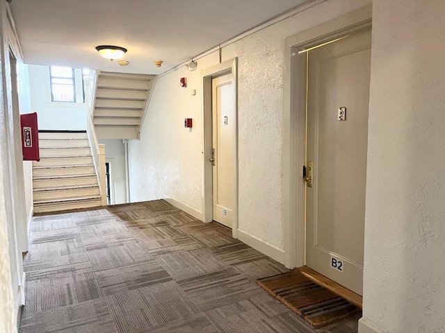 604 Tompkins Ave Unit B-2, Mamaroneck, NY 10543 - hallway with a textured wall, stairs, and carpet flooring