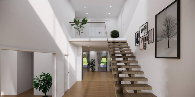 59 Shinnecock Hills Rd, Southampton, NY 11968 - staircase featuring a towering ceiling, wood finished floors, and recessed lighting