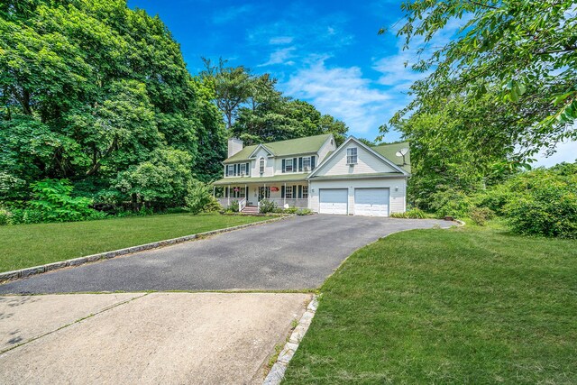 4 Ariel Ct, Rocky Point, NY 11778 - colonial inspired home with driveway, a porch, a front yard, a garage, and a chimney