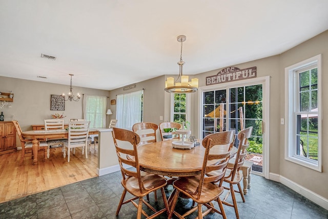 4 Ariel Ct, Rocky Point, NY 11778 - dining space with a chandelier and tile patterned floors