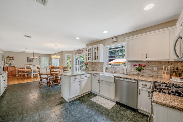4 Ariel Ct, Rocky Point, NY 11778 - kitchen with appliances with stainless steel finishes, a peninsula, healthy amount of natural light, white cabinetry, and recessed lighting