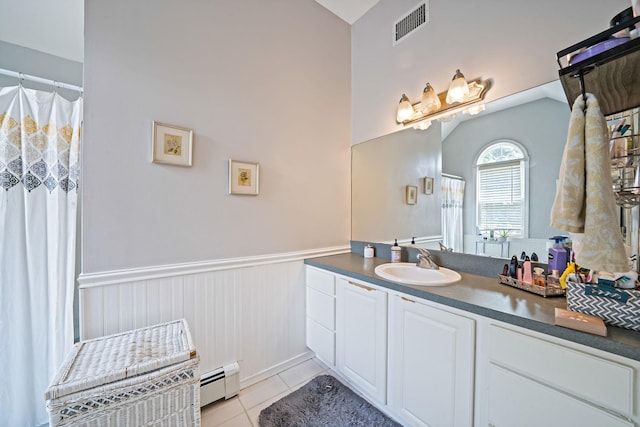4 Ariel Ct, Rocky Point, NY 11778 - full bath featuring baseboard heating, a wainscoted wall, vanity, tile patterned floors, and vaulted ceiling