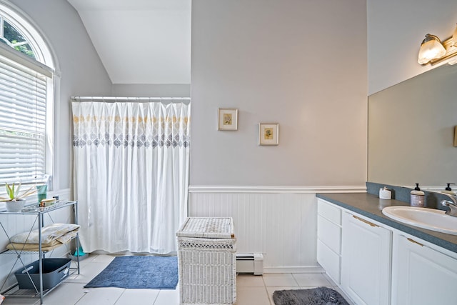 4 Ariel Ct, Rocky Point, NY 11778 - bathroom with baseboard heating, healthy amount of natural light, tile patterned flooring, vanity, and a wainscoted wall