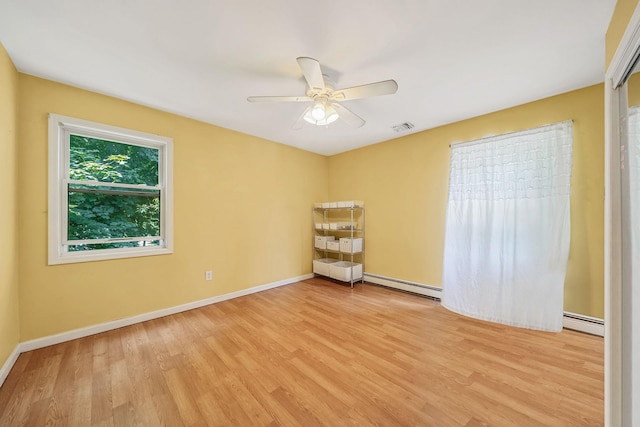 4 Ariel Ct, Rocky Point, NY 11778 - spare room featuring baseboard heating, light wood-style floors, and ceiling fan