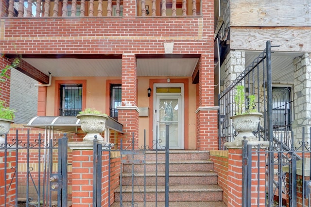 31 Tapscott St, Brooklyn, NY 11212 - entrance to property featuring brick siding, a gate, and covered porch