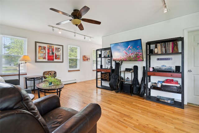 80 Diana Dr, Mastic Beach, NY 11951 - living room featuring rail lighting, baseboard heating, wood-type flooring, and a ceiling fan