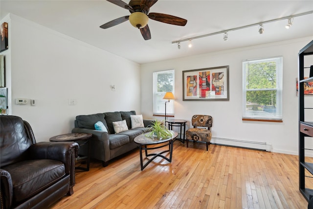 80 Diana Dr, Mastic Beach, NY 11951 - living room with a baseboard heating unit, plenty of natural light, light wood-style flooring, and ceiling fan