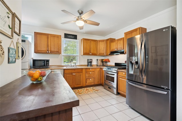 80 Diana Dr, Mastic Beach, NY 11951 - kitchen with appliances with stainless steel finishes, under cabinet range hood, a ceiling fan, brown cabinets, and light tile patterned flooring