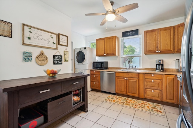 80 Diana Dr, Mastic Beach, NY 11951 - kitchen featuring stainless steel appliances, stacked washer / dryer, a sink, ceiling fan, and brown cabinets