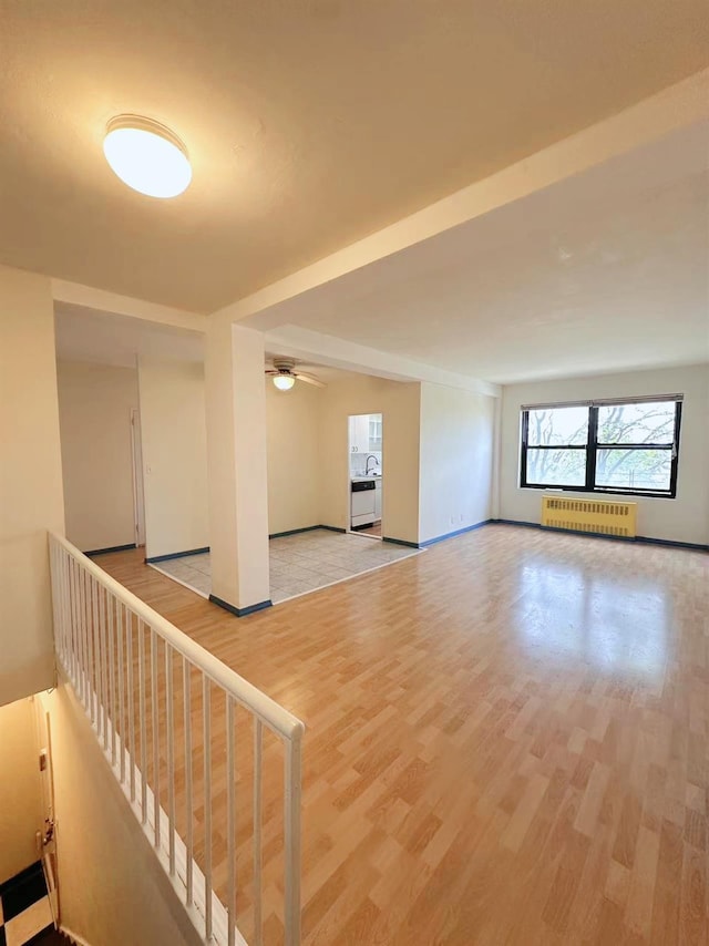 99-60 63rd Rd Unit 5W, Rego Park, NY 11374 - unfurnished room with radiator, light wood-style floors, a ceiling fan, and baseboards