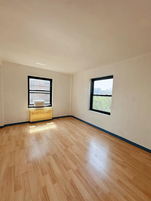 99-60 63rd Rd Unit 5W, Rego Park, NY 11374 - empty room with light wood-style floors and baseboards