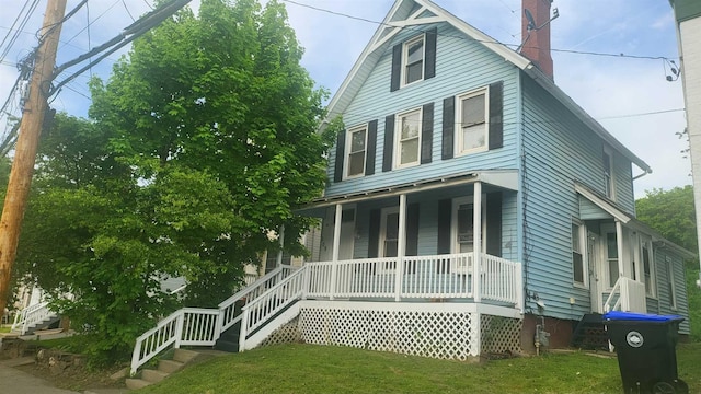 109 Garden St, Poughkeepsie, NY 12601 - view of front facade with a porch, a chimney, a front yard, and stairs