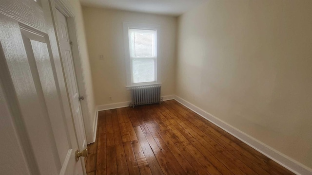109 Garden St, Poughkeepsie, NY 12601 - spare room with radiator, dark wood-type flooring, and baseboards